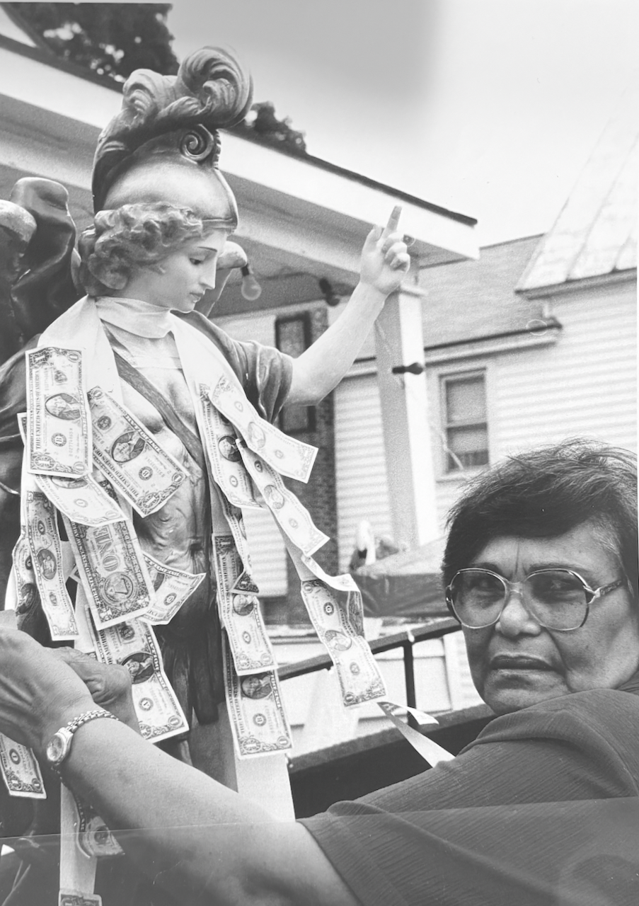 Archival Photo of St. Michael statue with dollars on Beekman Street in Saratoga Springs NY 1954